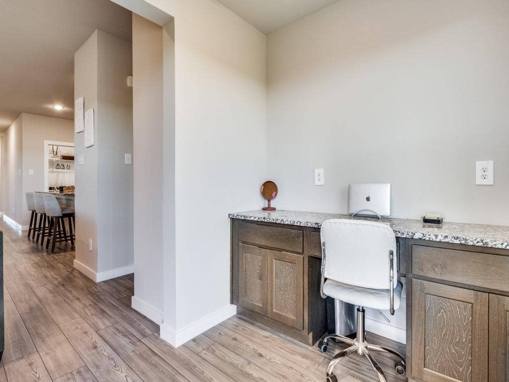 626 Congressional Avenue, Red Oak, TX 75154 Built-in desk area featuring a granite-style countertop, wood-finish cabinetry, and wood-finish flooring