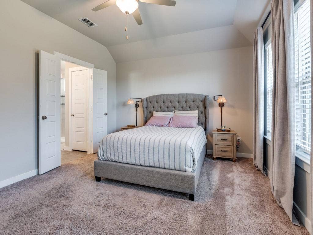 626 Congressional Avenue, Red Oak, TX 75154 Carpeted bedroom featuring a vaulted ceiling with a fan light fixture, white interior doors, and a window with blinds