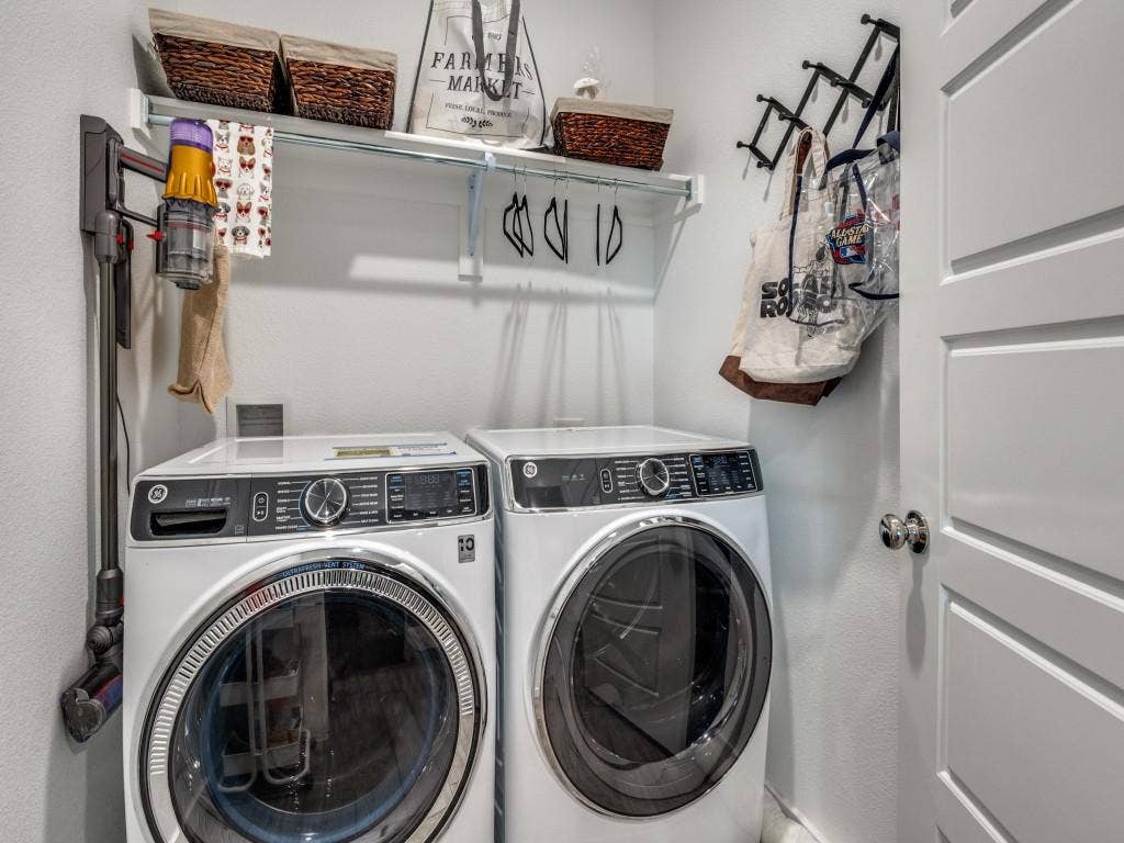 626 Congressional Avenue, Red Oak, TX 75154 Dedicated laundry area featuring a front-loading washer and dryer set