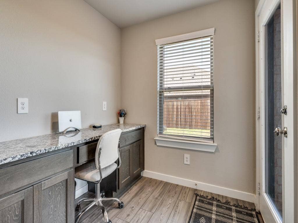 626 Congressional Avenue, Red Oak, TX 75154 Built-in desk featuring a stone-finish countertop and dark wood-finish cabinetry