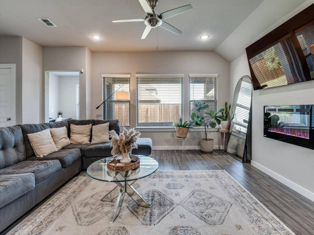 626 Congressional Avenue, Red Oak, TX 75154 Living area featuring wood-finish flooring, recessed lighting, a ceiling fan, multiple windows with blinds, and a built-in electric fireplace