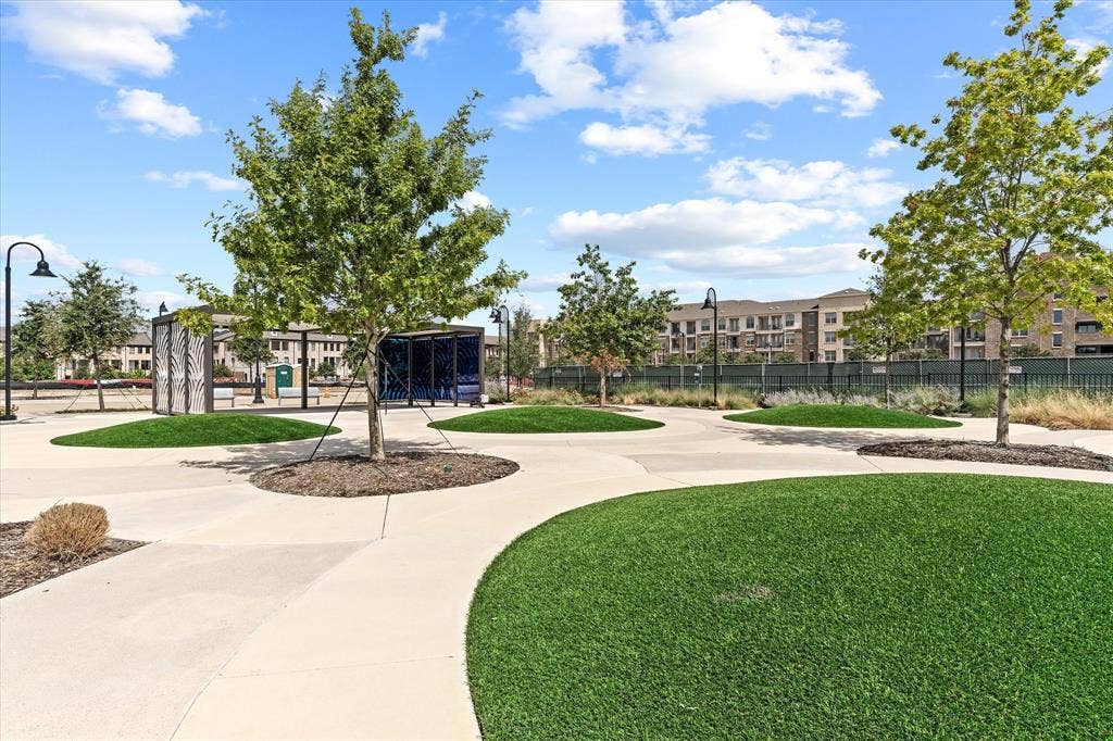 14956 Oak Street, Addison, TX 75001 Expansive outdoor space featuring concrete pathways and artificial turf islands