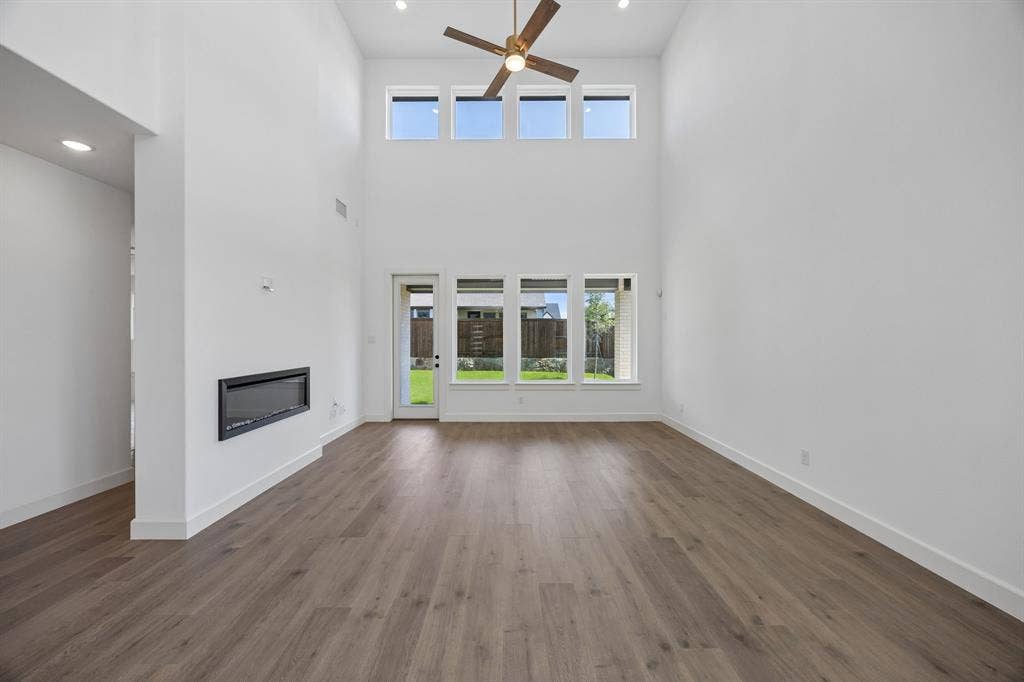4211 Rosita Lane, Prosper, TX 75078 Light filled and inviting, this spacious family room is the perfect place for you to host family gatherings.