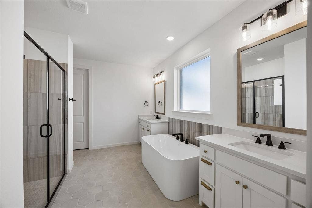 4211 Rosita Lane, Prosper, TX 75078 Featuring his & her vanities plus a wonderful soaking tub, this owner's bath is a dream come true!