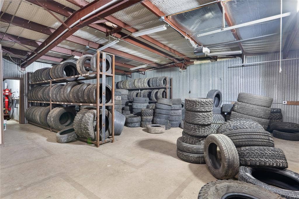 807 W Corsicana Street, Athens, TX 75751 Spacious industrial interior featuring corrugated metal walls and concrete flooring