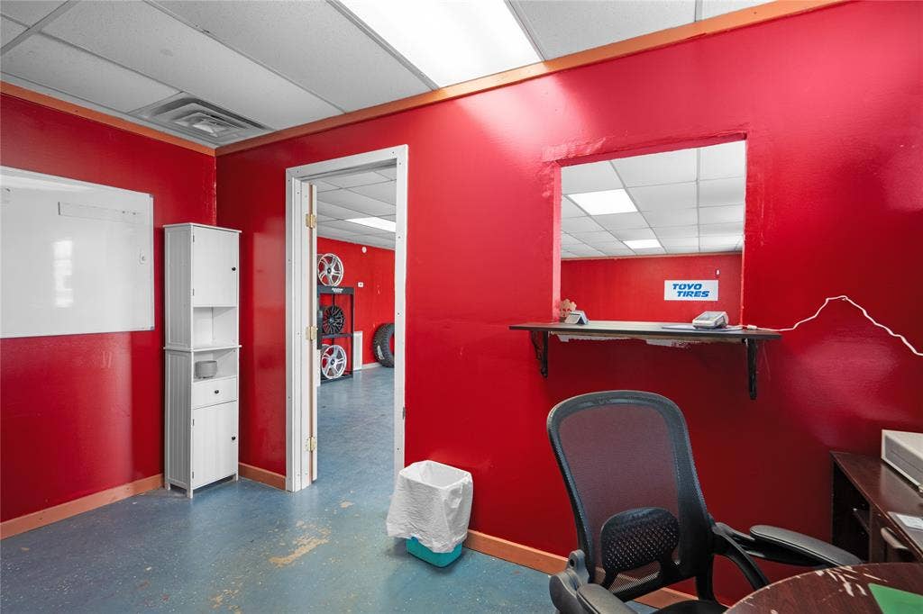 807 W Corsicana Street, Athens, TX 75751 Commercial space featuring vibrant red walls and blue flooring