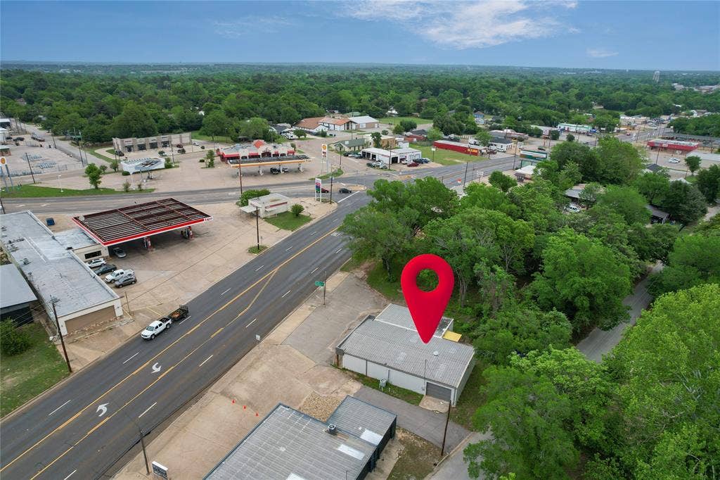807 W Corsicana Street, Athens, TX 75751 Commercial property with a flat roof and light-colored exterior walls, featuring direct frontage on a multi-lane paved road