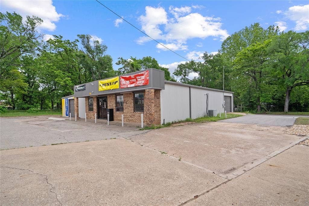 807 W Corsicana Street, Athens, TX 75751 Commercial building featuring a brick facade and corrugated metal siding