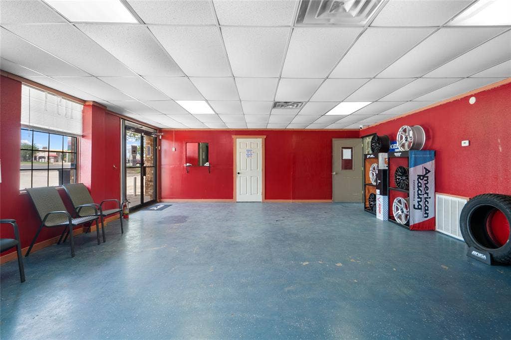 807 W Corsicana Street, Athens, TX 75751 Spacious interior featuring a commercial-grade dropped ceiling with integrated lighting, durable flooring, and large storefront windows