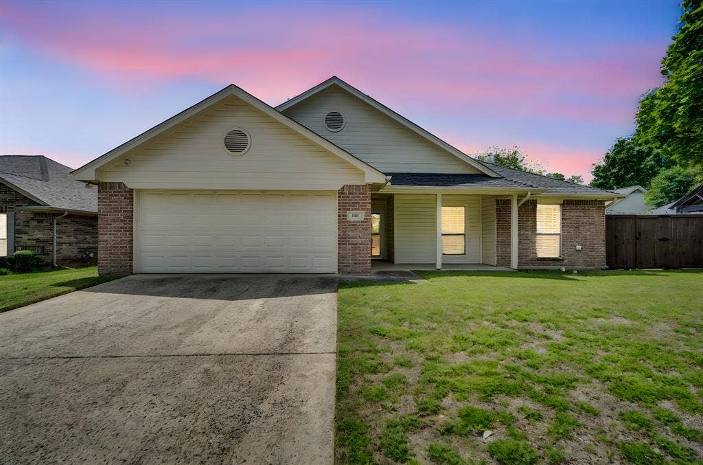 506 Whitney Drive, Midlothian, TX 76065 Single-story residence featuring a two-car garage, brick and siding facade, covered front entry, and a concrete driveway