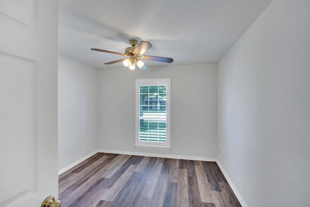506 Whitney Drive, Midlothian, TX 76065 Bedroom featuring wood-finish flooring, a ceiling fan with integrated lighting, and a window with plantation-style shutters