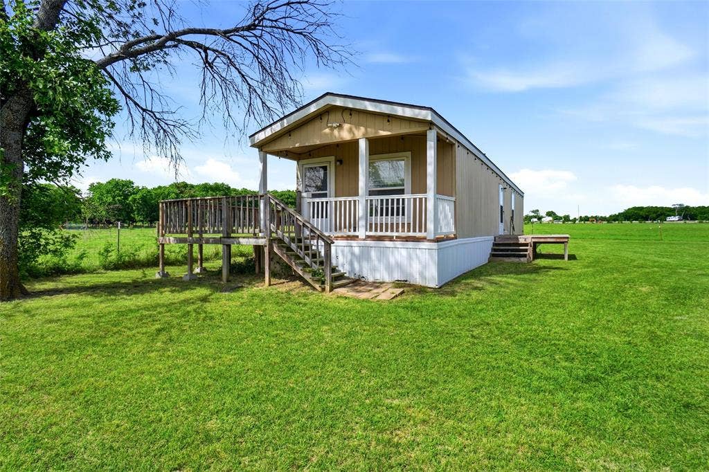 8983 W Odneal Road, Krum, TX 76249 Mobile home is house#2. The home is not "attached" to the land. It is real property. 2 bedrooms and 2 full bathrooms.