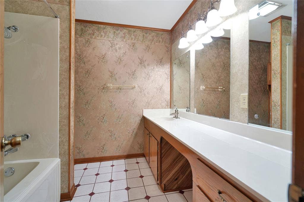 1114 Brookshire Drive, Tyler, TX 75071 Bathroom featuring a long single vanity with an integrated sink, dual mirrors, and overhead light fixture