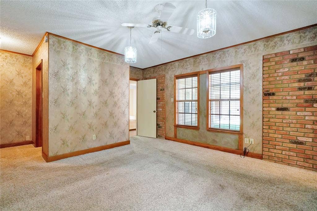 1114 Brookshire Drive, Tyler, TX 75071 Carpeted interior space featuring a textured ceiling, a ceiling fan with integrated lighting, and two windows with blinds