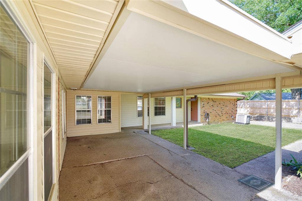 1114 Brookshire Drive, Tyler, TX 75071 Covered concrete patio extending along the rear exterior