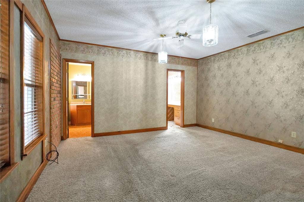 1114 Brookshire Drive, Tyler, TX 75071 Spacious interior room with light-toned carpet flooring and a ceiling fan with integrated lighting