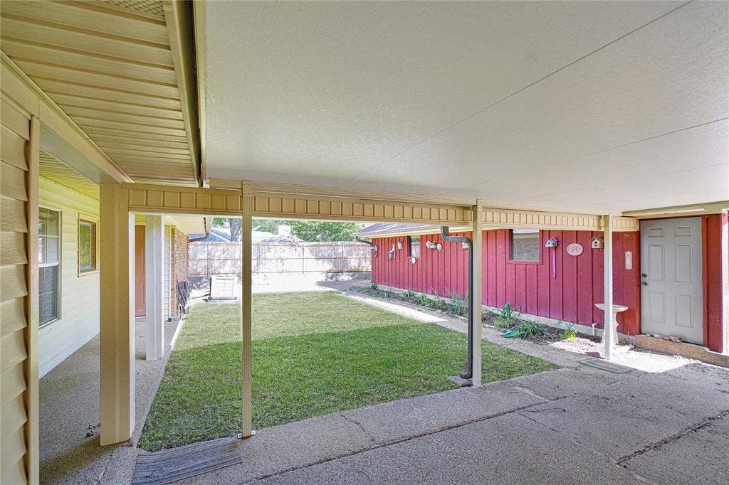 1114 Brookshire Drive, Tyler, TX 75071 Covered patio area with concrete flooring, framed by light-colored support columns