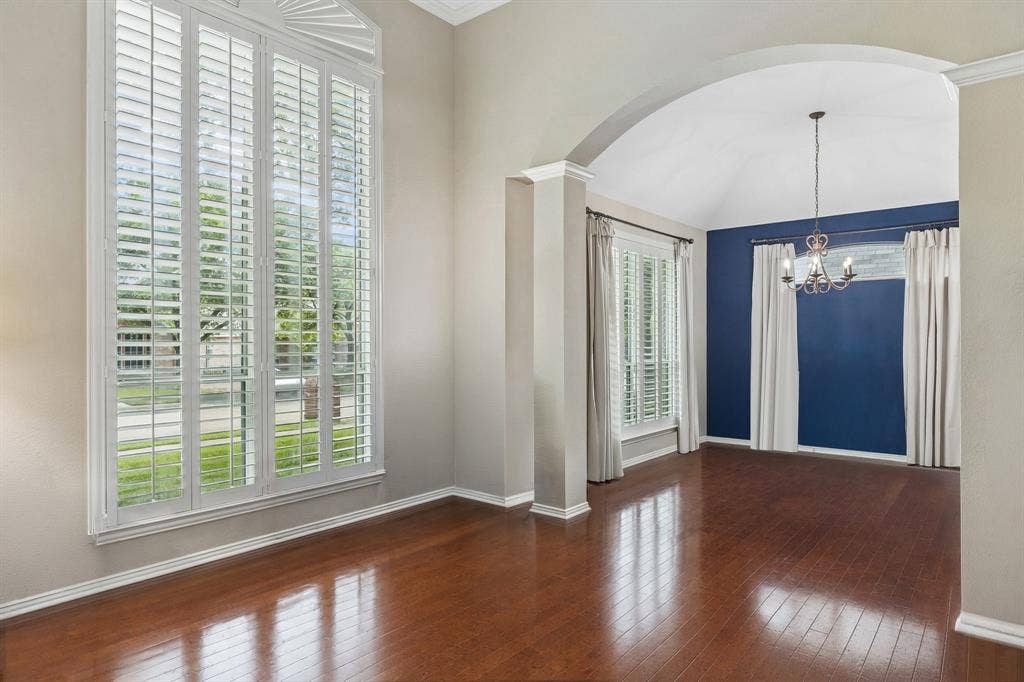1105 Easton Lane, Allen, TX 75002 The living room enjoys abundant natural light from oversized windows with Plantation Shutters. Gleaming hardwood flooring completes the space. The graceful arched opening with pillars gives definition to the dining room.