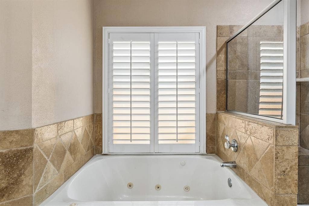 1105 Easton Lane, Allen, TX 75002 Jetted tub with separate shower have stylish tile surround.