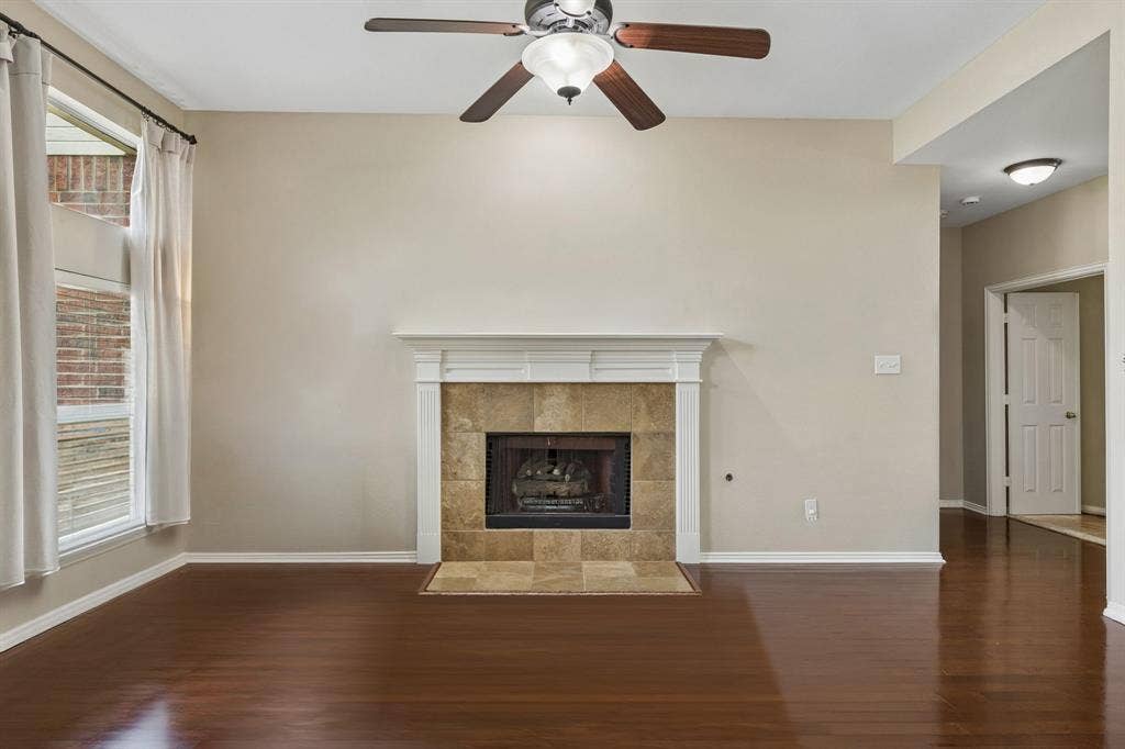 1105 Easton Lane, Allen, TX 75002 The family room is anchored by a fireplace with gas logs and stone surround. Other features include ceiling fan and hardwood flooring.