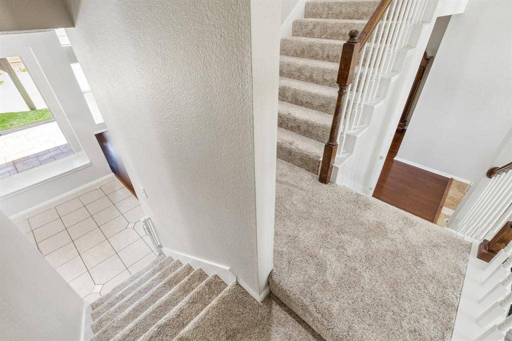 1105 Easton Lane, Allen, TX 75002 The stairs split from the landing to either the kitchen or the entry. So convenient! Find awesome storage under the stair!