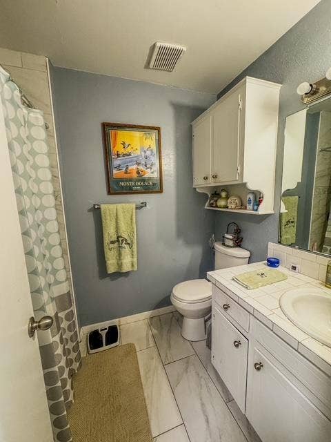 5230 Fm 2495, Athens, TX 75752 Bathroom featuring white tile-look flooring, a toilet, and a vanity with a drop-in sink