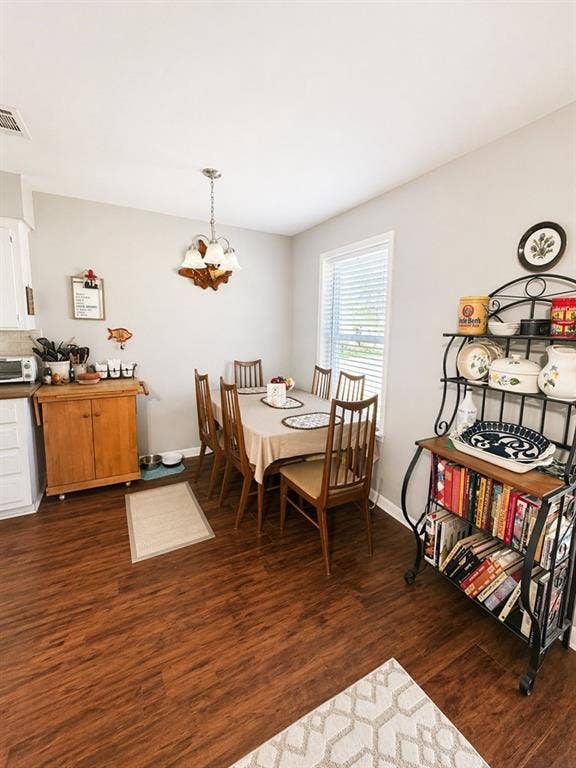 5230 Fm 2495, Athens, TX 75752 Dining area featuring wood-finish flooring, a chandelier, and ample natural light from a window with blinds