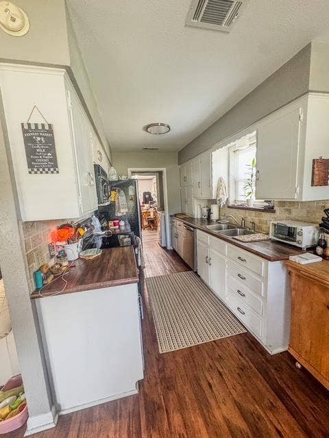 5230 Fm 2495, Athens, TX 75752 Galley kitchen featuring wood-finish flooring, white cabinetry, and wood-finish countertops