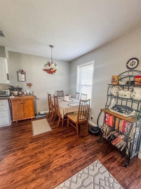 5230 Fm 2495, Athens, TX 75752 Dining area featuring wood-finish flooring, a window with blinds, and an overhead light fixture