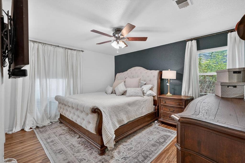 224 Hudson Avenue, Crowley, TX 76036 Spacious room featuring wood-finish flooring, a ceiling fan with light fixture, and a window with blinds providing natural light