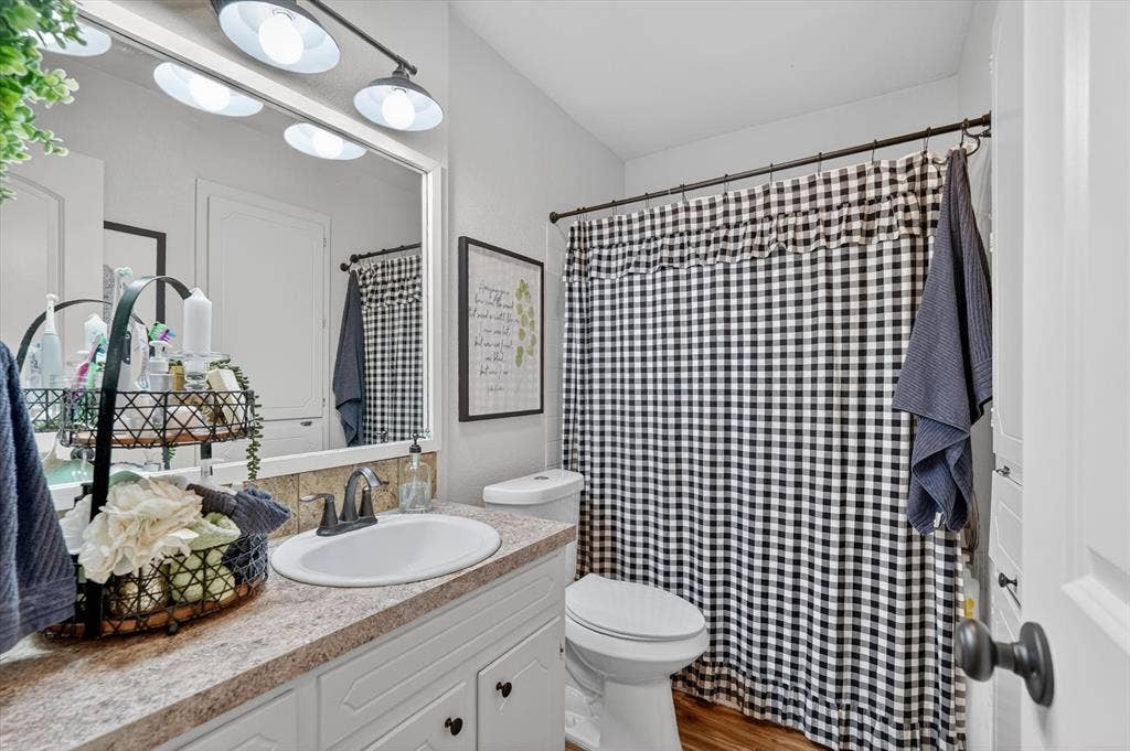 224 Hudson Avenue, Crowley, TX 76036 Bathroom vanity with a white oval sink, dark bronze faucet, and a light-toned countertop