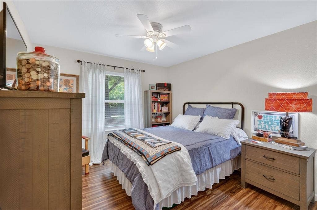 224 Hudson Avenue, Crowley, TX 76036 Room featuring wood-finish flooring, a ceiling fan with light fixture, and a window with blinds