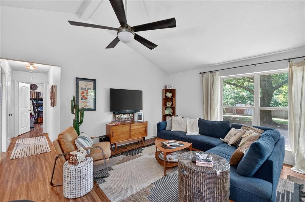 224 Hudson Avenue, Crowley, TX 76036 Living area featuring vaulted ceilings, wood-finish flooring, a contemporary ceiling fan, and large windows with outdoor scenery
