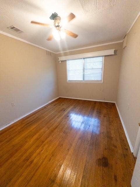 613 Laurel Road, Athens, TX 75751 Hardwood flooring throughout featuring white baseboards, a ceiling fan with light fixture, and a window with horizontal blinds