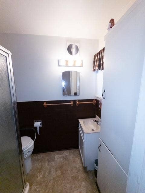 613 Laurel Road, Athens, TX 75751 Full bathroom featuring a white vanity with integrated sink, patterned floor tiling, and a separate shower enclosure