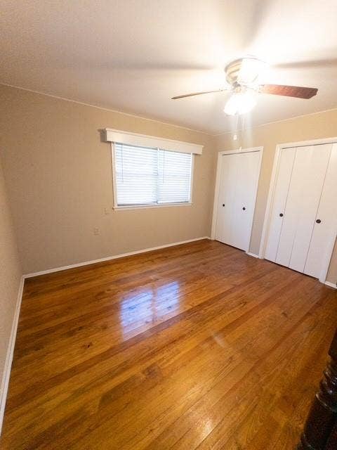 613 Laurel Road, Athens, TX 75751 Bedroom featuring wood-finish flooring, neutral wall color, and a ceiling fan with integrated lighting