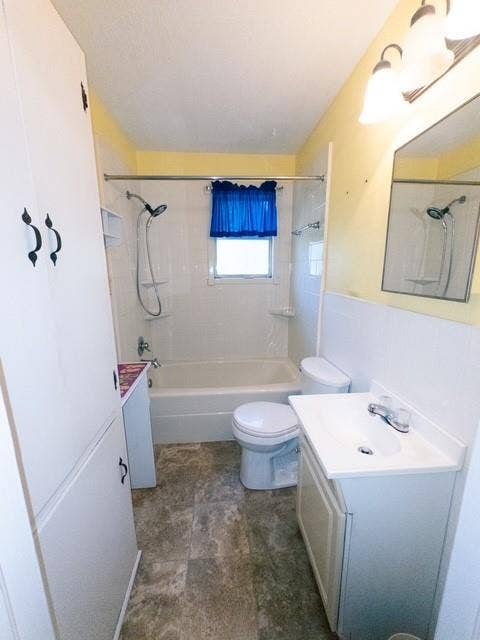 613 Laurel Road, Athens, TX 75751 Bathroom featuring a white bathtub, ceramic tile surround, built-in storage cabinetry, and a vanity with an integrated sink