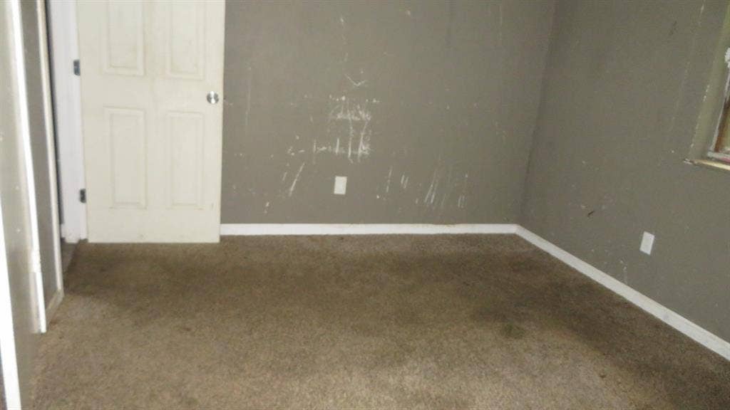 6525 Palm Island Street, Dallas, TX 75241 Carpeted interior space featuring a paneled door, baseboard molding, and%2