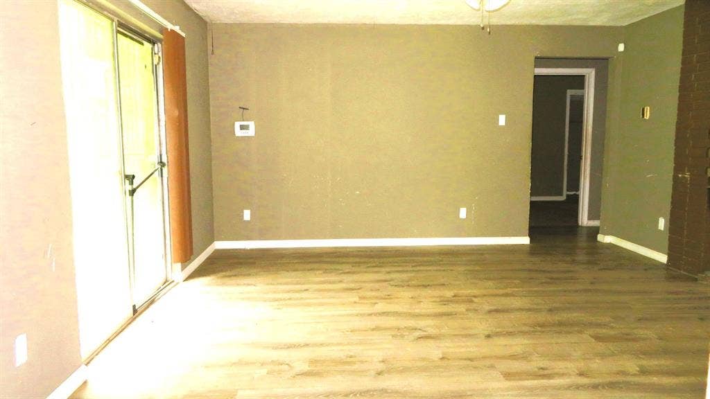 6525 Palm Island Street, Dallas, TX 75241 Spacious interior featuring wood-finish flooring, a ceiling fan, and sliding glass doors