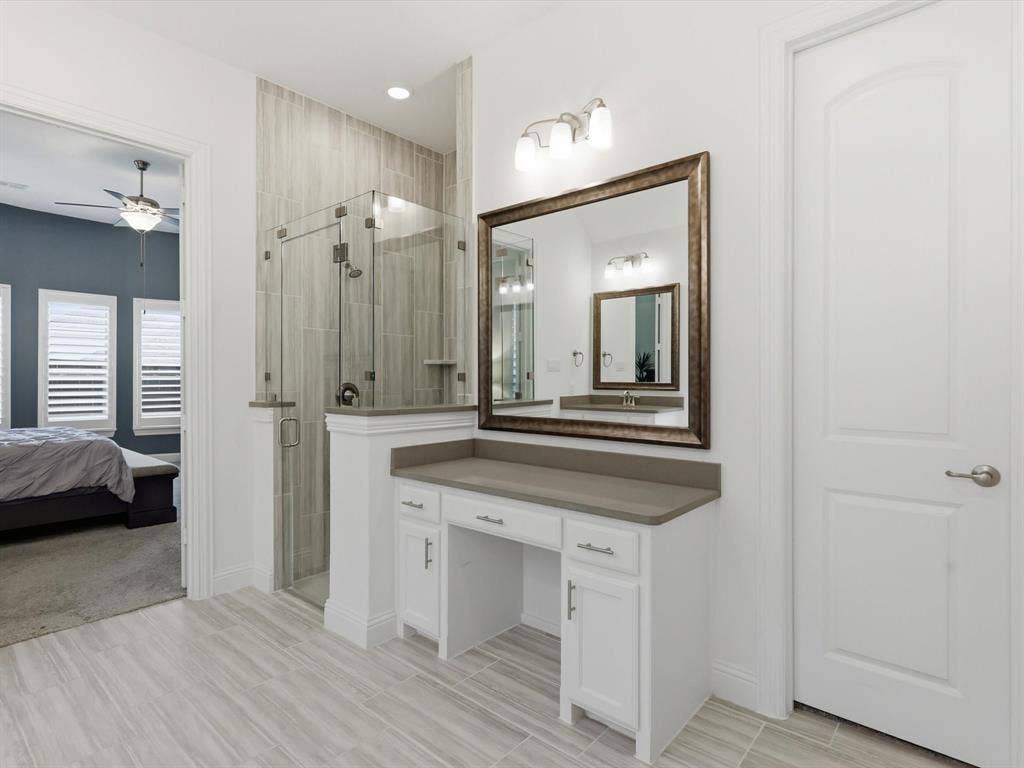 Light-filled primary bathroom with spacious layout and convenient flow into dual walk-in closets.