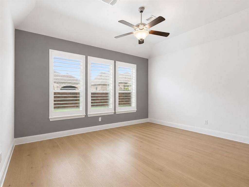 Light wood-finish flooring complements a gray accent wall