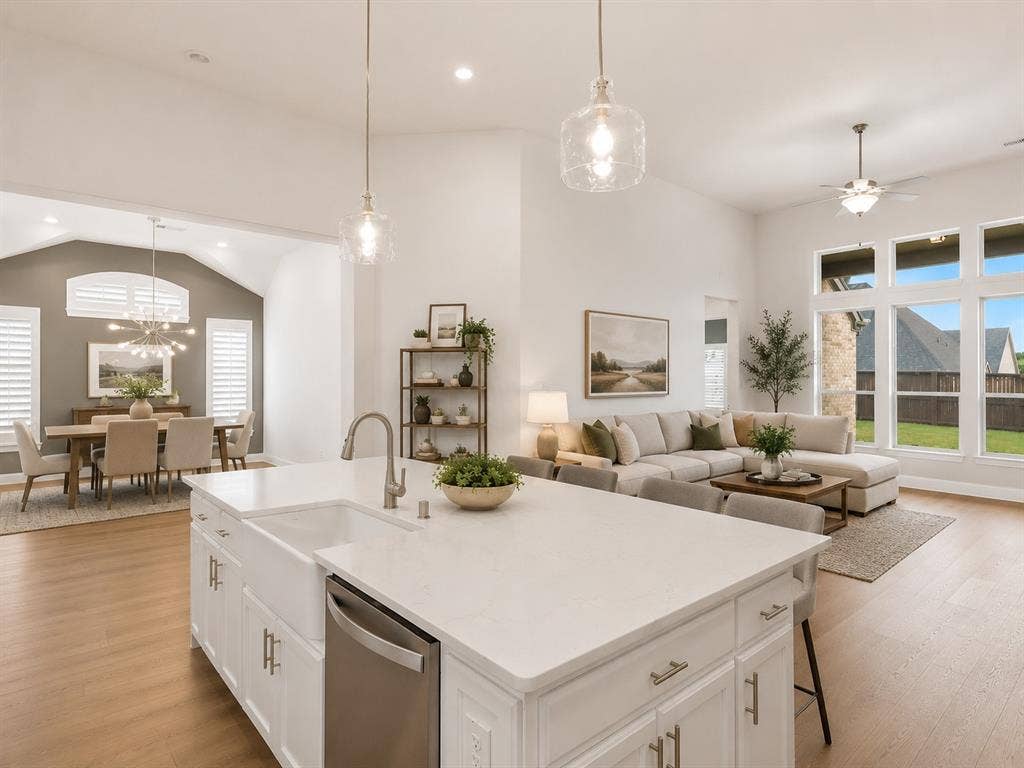 Expansive kitchen island with a farmhouse sink and integrated dishwasher. This image has been virtually enhanced for marketing purposes.