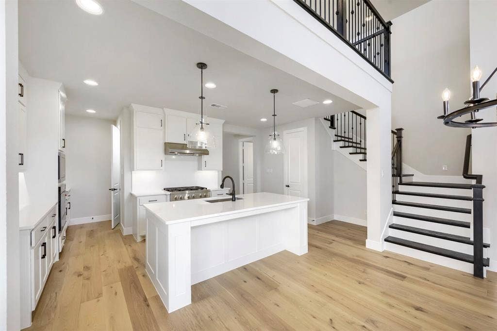 800 Blackberry Road, Haslet, TX 76052 Open-concept kitchen and living area featuring a central island with countertop seating, stainless steel appliances, and recessed lighting