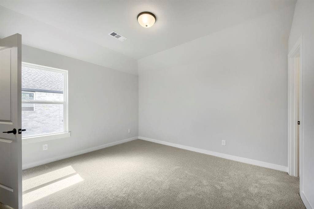 800 Blackberry Road, Haslet, TX 76052 This room features light gray wall paint, a single window with white trim, a flush mount ceiling light, and gray carpeting