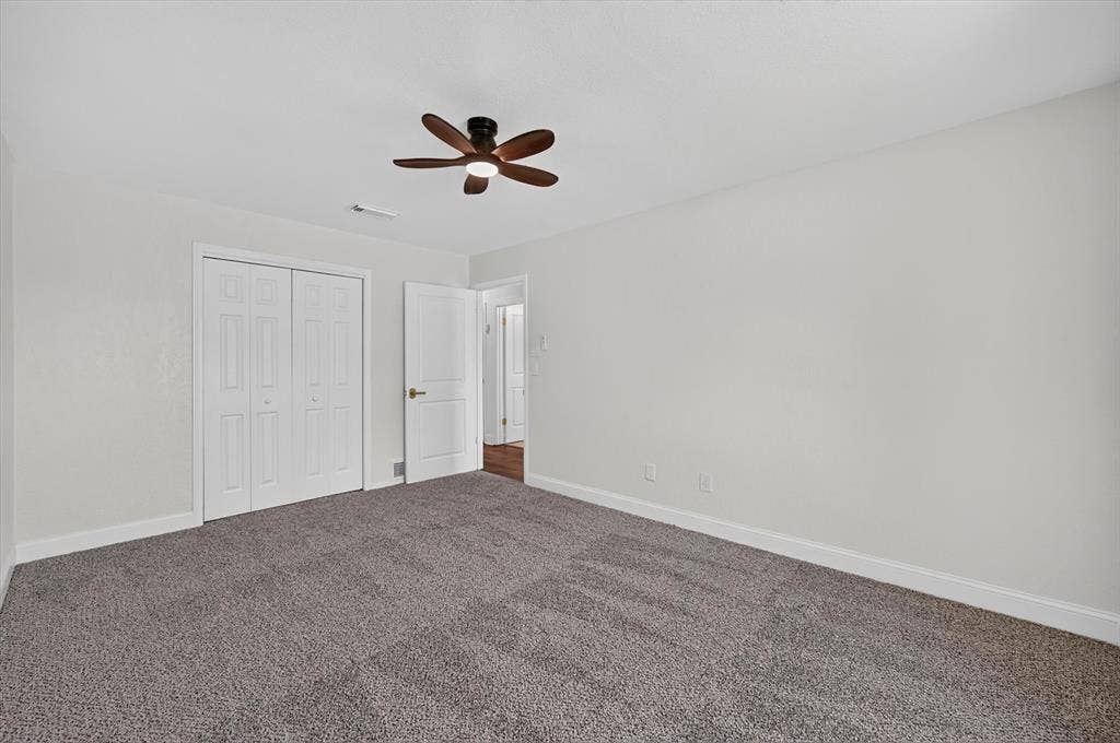 3420 Denbury Drive, Fort Worth, TX 76133 Spacious room featuring neutral carpeting, light gray wall paint, and white trim