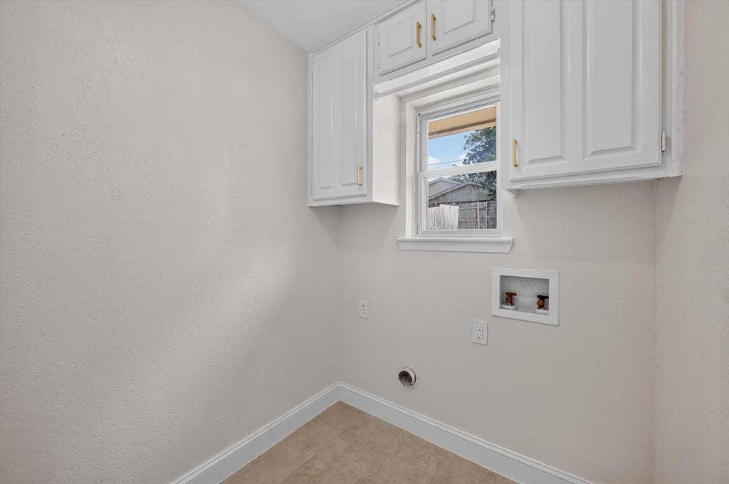 3420 Denbury Drive, Fort Worth, TX 76133 Dedicated utility space featuring white upper cabinetry, a window, and durable tile flooring
