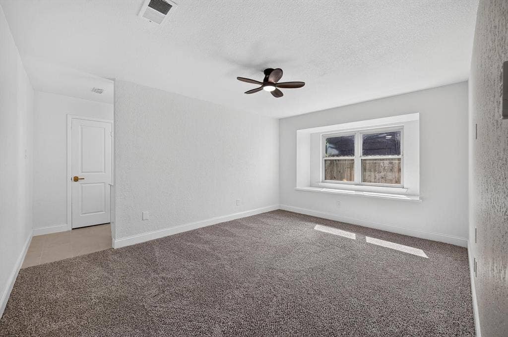 3420 Denbury Drive, Fort Worth, TX 76133 Bedroom featuring neutral-toned carpet, a window with a deep sill, and a ceiling fan
