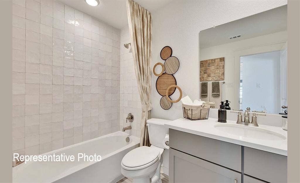 1579 Gentle Night Drive, Forney, TX 75126 Bathroom featuring a white subway-tiled shower, a soaking tub, a single vanity with a white countertop, and a large wall-mounted mirror