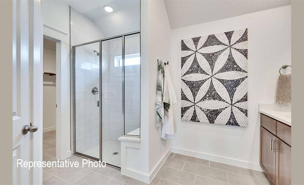 1579 Gentle Night Drive, Forney, TX 75126 Modern bathroom featuring a glass-enclosed shower with subway tile surround and built-in bench
