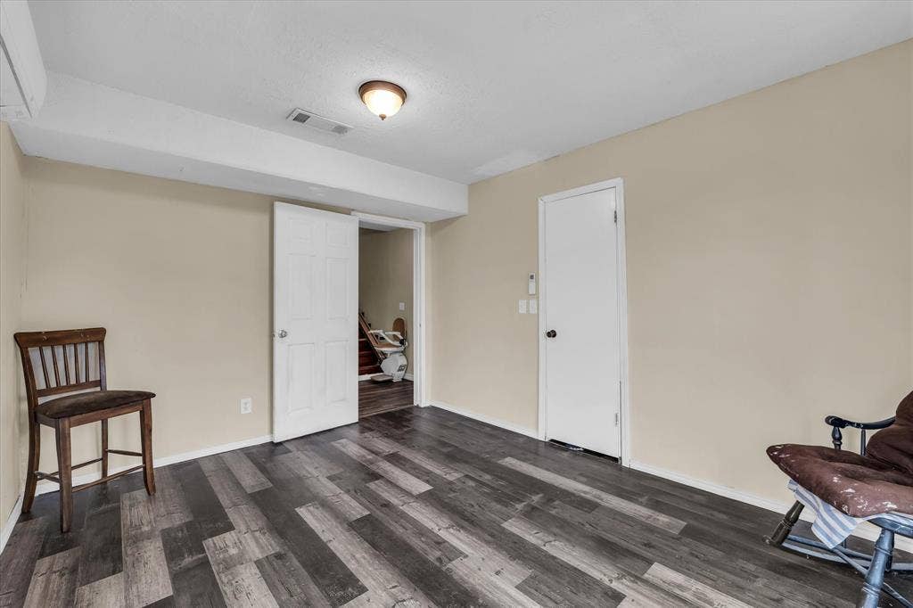 12912 Spring Valley Road, Moody, TX 76557 Spacious interior room featuring wood-finish flooring, neutral wall tones, and recessed ceiling lighting